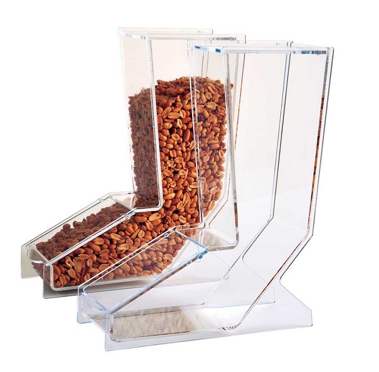 Front view of the gravity-feed bulk dispenser showing the clear acrylic body, front access door, and included white scoop.