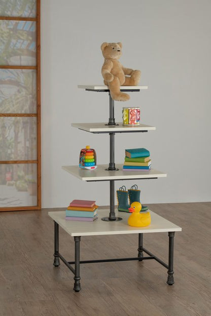 Front view of a 4-tier square display white table shown with a sturdy metal base and wood tiers, designed for multi-level merchandising in retail and hospitality environments.