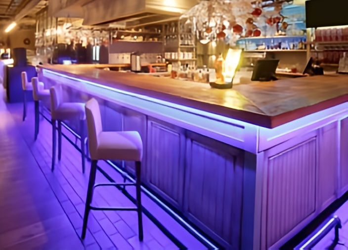 Bar counter with stools in a dimly lit bar setting