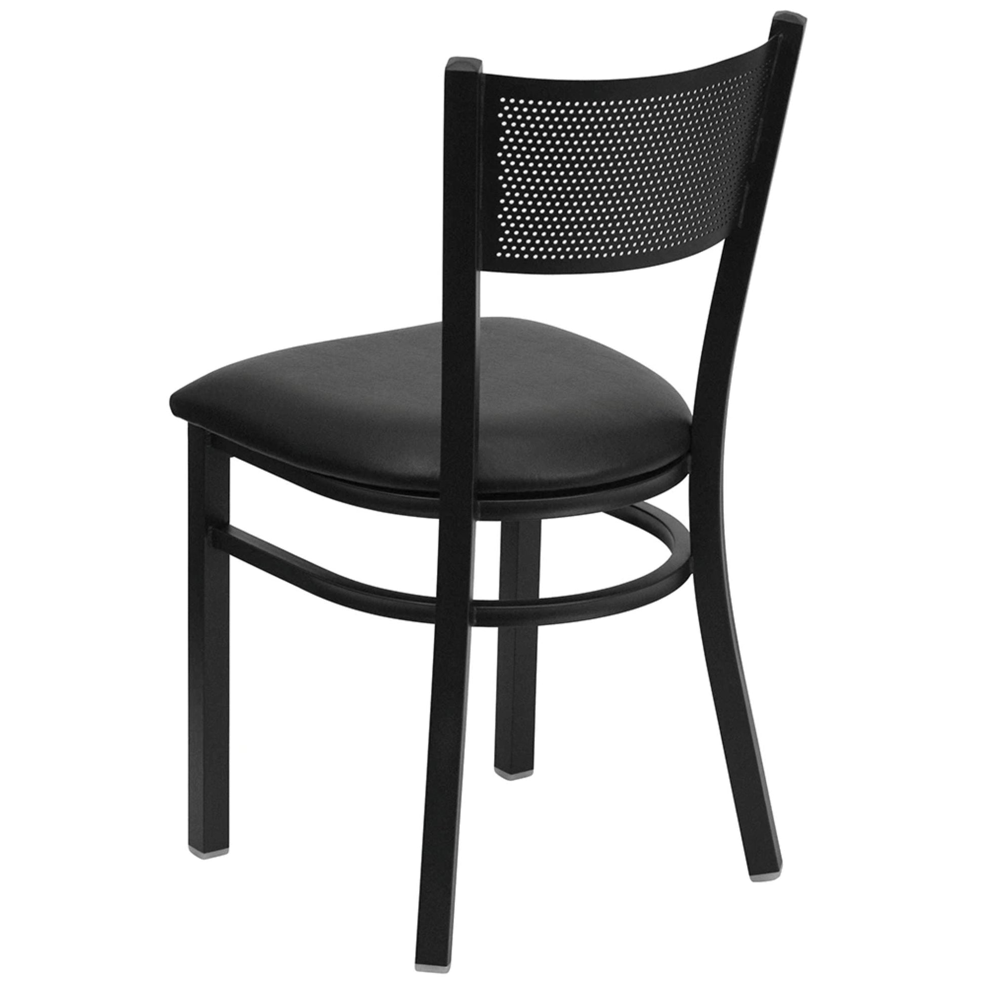 Back view of Black steel restaurant chair with grid back design and black vinyl seat, shown on a dining floor