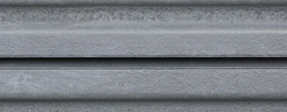 Close-up of corrugated silver metal panel surface with metallic texture.