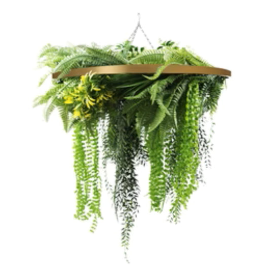 gold framed hanging disc with tropical plants and draping ferns