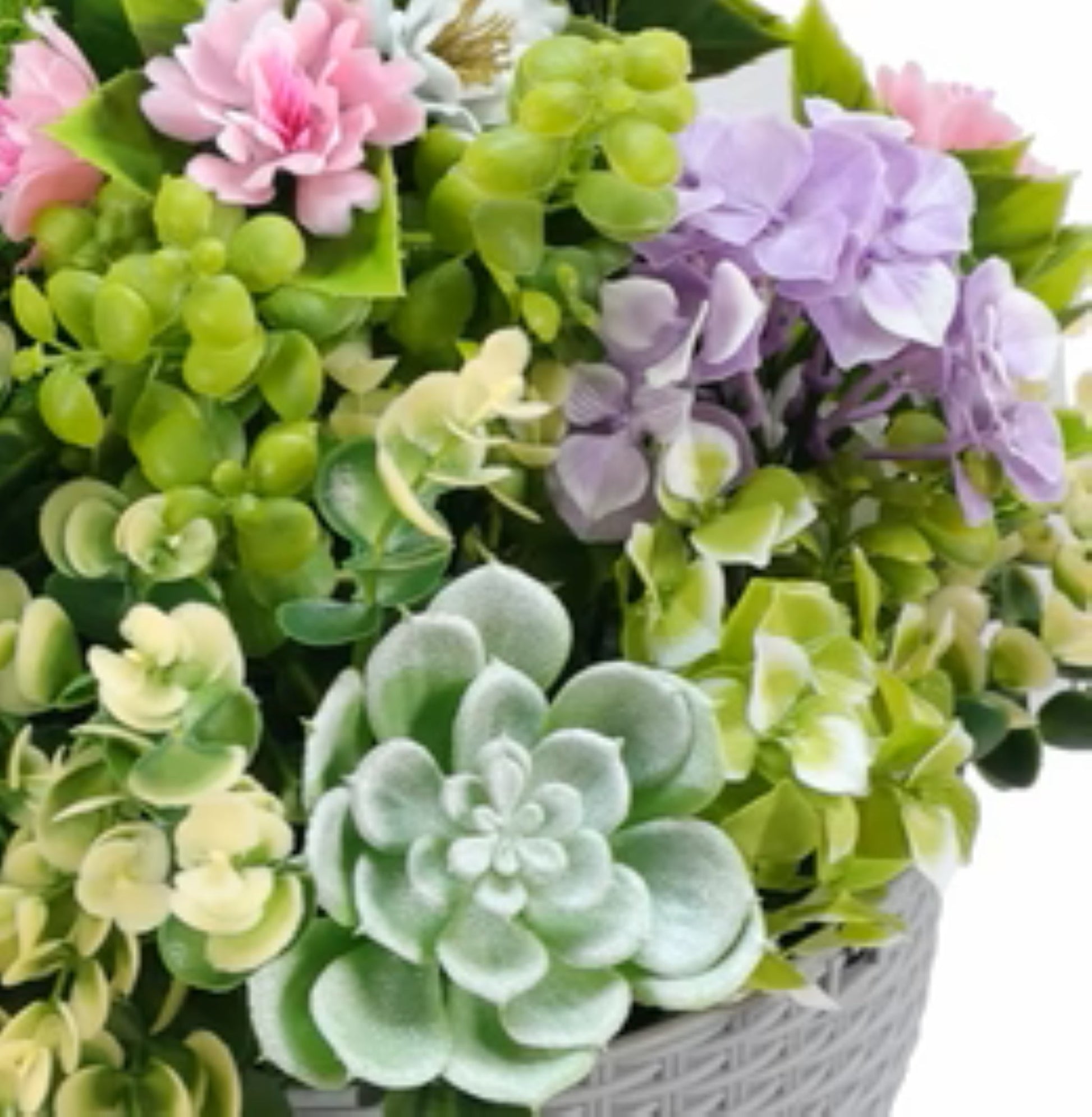 Realistic cascading succulent arrangement in grey woven pot