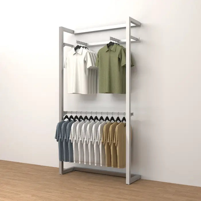 Rectangular tubing installed on a wall display system with garments hung face-out, demonstrating the tubing’s stability and use in a retail or hospitality apparel display.