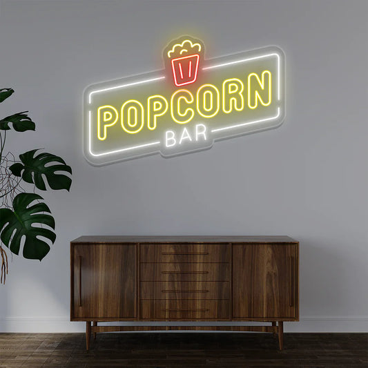 Popcorn Bar LED Neon Sign in warm white light adding vintage movie-theater ambiance to entertainment room or bar wall.