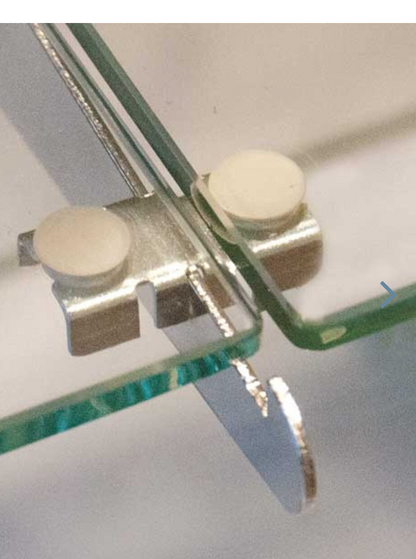 Close-up detail of the shelf rest’s rubber bumpers and satin finish, highlighting the notched design used for secure shelf placement.