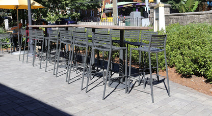 Emu Segno Bar E264 barstool in iron finish with slatted steel seat and back in a outdoor patio space.