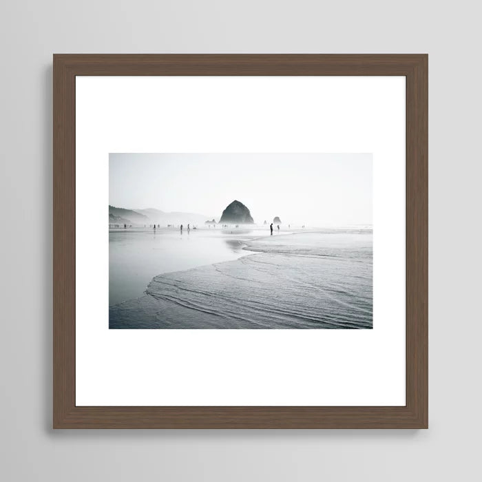 Cannon Beach Art Print by Hannah Kemp in walnut wood frame, featuring tranquil ocean imagery ideal for hotels, restaurants, and contemporary beachside cafés.