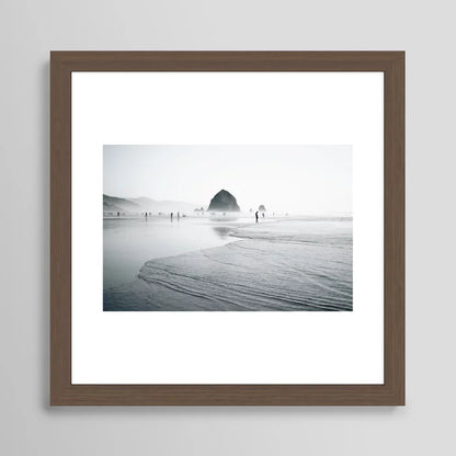 Cannon Beach Art Print by Hannah Kemp in walnut wood frame, featuring tranquil ocean imagery ideal for hotels, restaurants, and contemporary beachside cafés.
