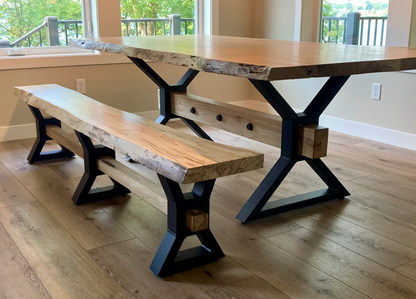 Three-quarter angled view of heavy-duty farmhouse style steel table legs with 1.5 x 3 inch tubing, large mounting plate, 4 x 4 inch center opening for wood beam installation, shown with adjustable leveling feet