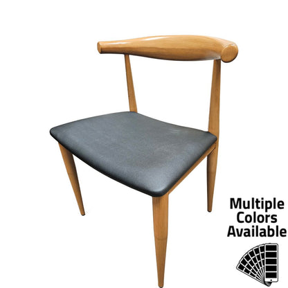 Front view of Elbow Dining Chair with faux wood grain metal frame and black vinyl seat, showing curved backrest and mid-century modern design.