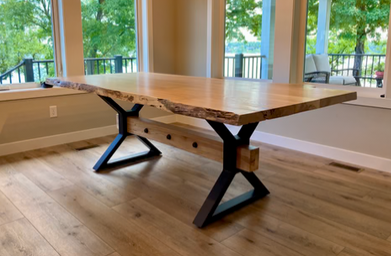 Front view of heavy-duty farmhouse table legs made from 1.5 x 3 inch steel tubing with a 6 x 28 inch mounting plate, 4 x 4 inch center opening for wood beams, rustic industrial style, shown with adjustable threaded feet.