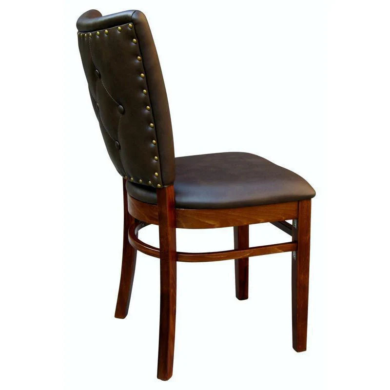 Side view of the Lima upholstered beech wood dining chair showing seat design wrapping around the sides, smooth wood frame, and brass decorative nail trim. Custom upholstery and wood stain options available.
