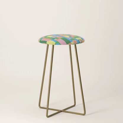 Mozaika 2 Counter Stool by Gigi Rosado with gold steel legs – vibrant geometric vegan leather seating for cafés, hotel dining areas, and restaurant counters