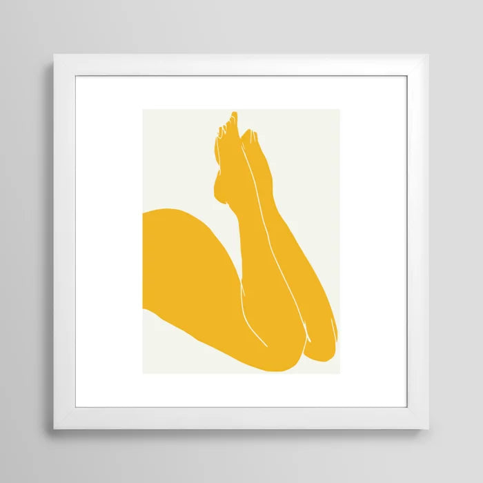Nude in Yellow 3 art print in white frame on café wall