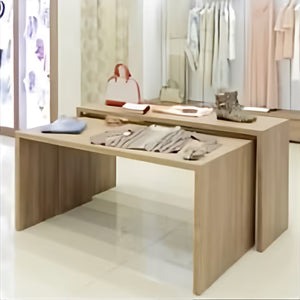 Front view of a Parsons Style Nesting Display Table with merchandise arranged on the tabletop, showing how the clean, modern design is used for presenting apparel, accessories, and décor in a retail environment.