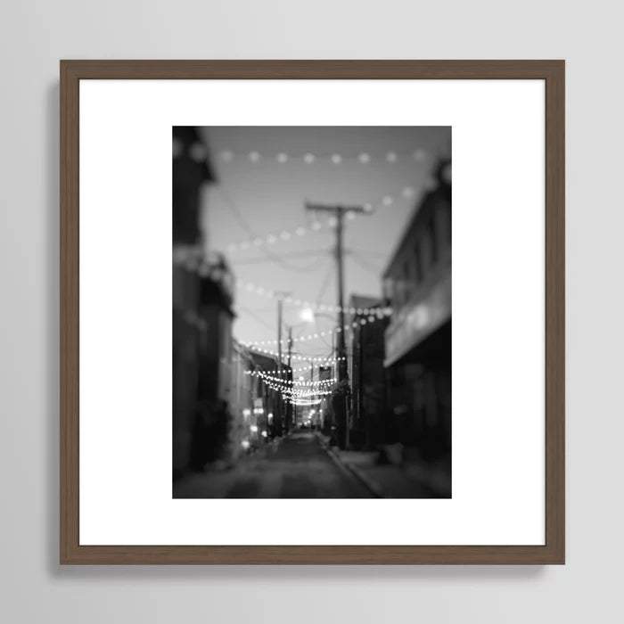 Alt Text:
Party Lights in the City Baltimore Maryland Art Print in walnut frame – rich dark wood frame enhances restaurant and hotel décor with a sophisticated city-night aesthetic
