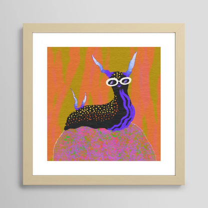 Sea Slug art print by Blindthesun in light maple frame highlighting soft wood grain and contemporary coastal style
