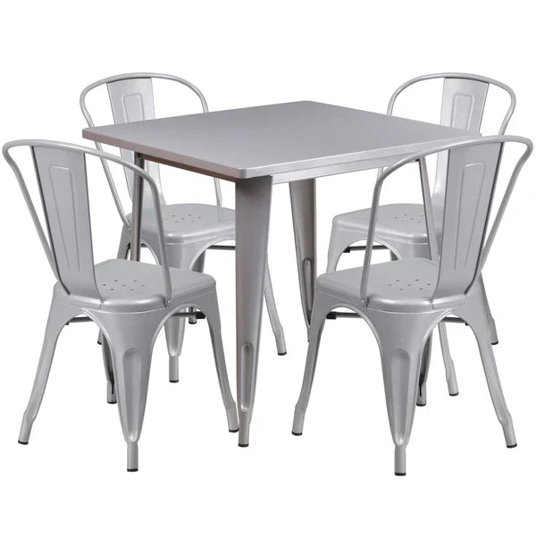 Silver finish metal restaurant table set with four stackable chairs for hotel dining or bar patios