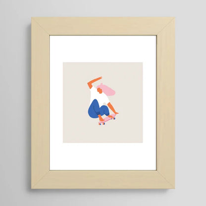 Skateboard Girl art print by Tasiania in a light maple frame, featuring a youthful skateboard scene perfect for art walls, cafés, or bedroom décor