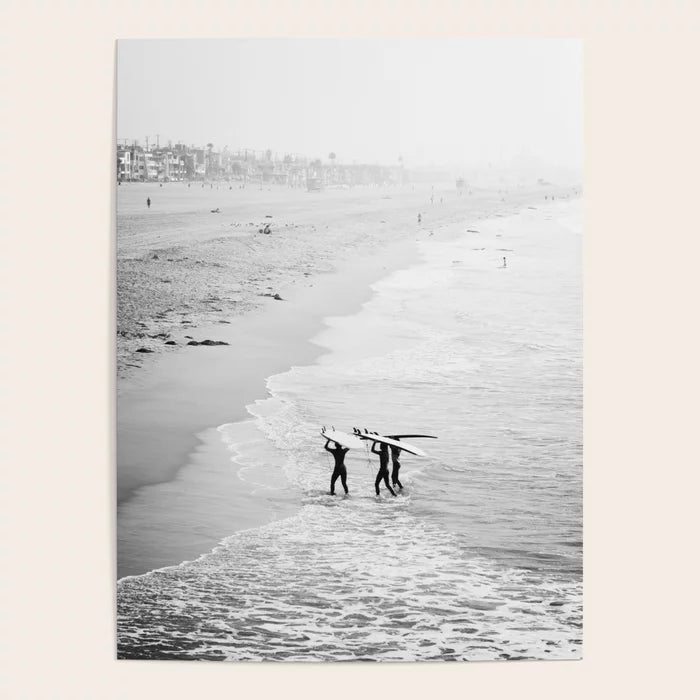 Surfers exiting the water at Manhattan Beach photography poster displayed in café interior