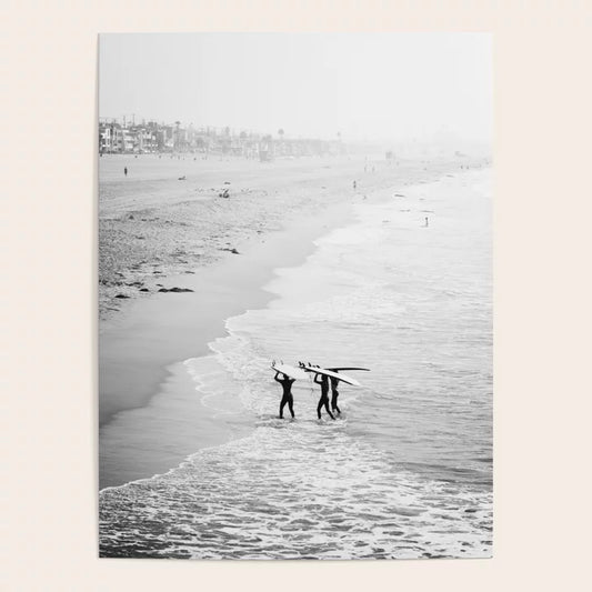 Surfers exiting the water at Manhattan Beach photography poster displayed in café interior