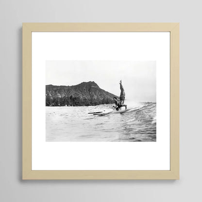 Surfing Diamond Head, Hawaii Art Print by Vintage Surf Photos framed in light maple wood – coastal wall décor featuring Waikiki surfers and iconic Diamond Head backdrop