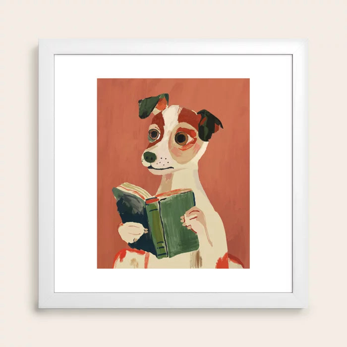 White framed artwork of a dog reading a book on a red background