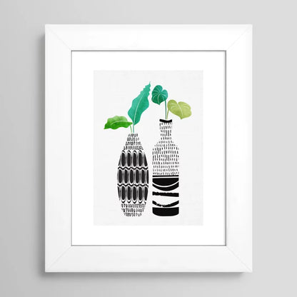 Botanical wall art print in white frame featuring tribal vase pattern and greenery