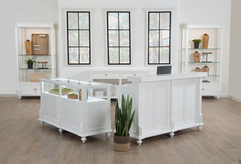 Front view of the Vintage Jewelry Showcase in a white painted finish, showing the locking glass display area with LED lighting and the lower storage compartments used for secure retail merchandising.