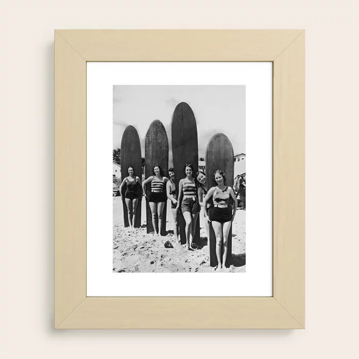 Woman Surfers vintage black and white surf art print by Vintage Vivian with light maple frame bringing warm natural tones to beach-inspired spaces